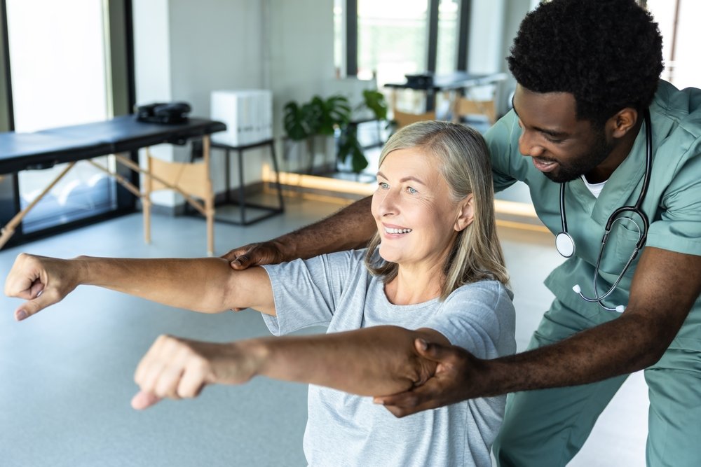 man,chiropractor,assisting,adult,woman,patient,with,pain,relief,and